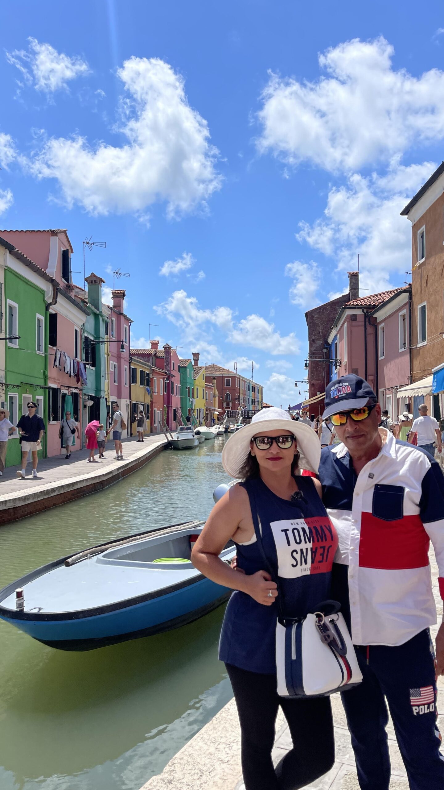 un hombre y una mujer en uno de los canales de Burano en Venecia